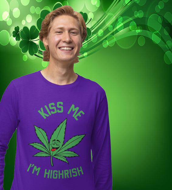 unisex t-shirt featuring a playful green cannabis leaf with a funny face, tongue out, and the words "Kiss Me I’m Highrish" in bold, festive lettering.