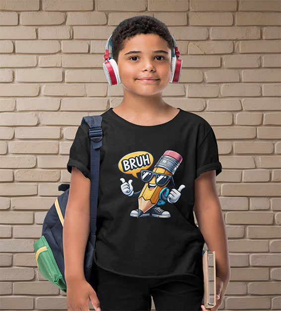 Young school-aged child wearing a black t-shirt with a funny cartoon pencil graphic and the text “BRUH, WE BACK.” The kid is wearing headphones, holding a book, and standing in front of a beige brick wall. Ideal for back-to-school outfits