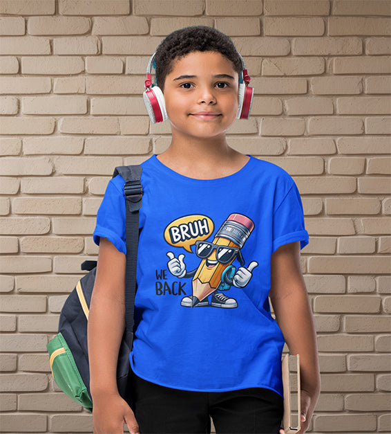 Young school-aged child wearing a true royal t-shirt with a funny cartoon pencil graphic and the text “BRUH, WE BACK.” The kid is wearing headphones, holding a book, and standing in front of a beige brick wall. Ideal for back-to-school outfits