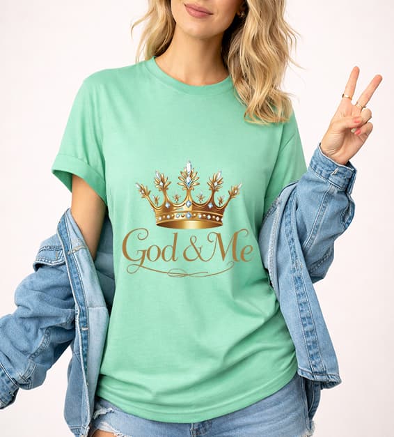 Young woman wearing mint God and Me crown graphic t-shirt with gold design, faith-based Christian apparel