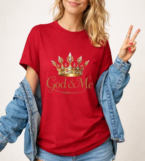 Young woman wearing red God and Me crown graphic t-shirt with gold design, faith-based Christian apparel,