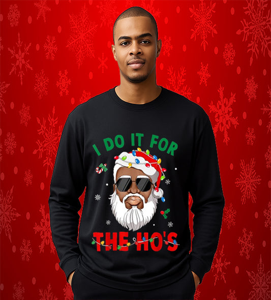 “Funny Black Santa Christmas sweatshirt with sunglasses, Santa hat wrapped in colorful lights, and festive red and green text reading ‘I Do It For The Ho’s.’”
