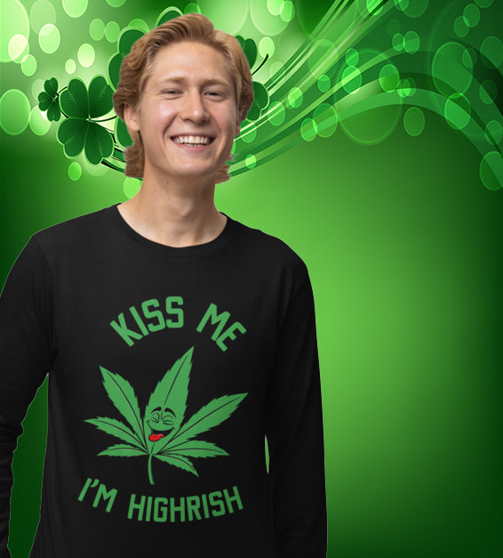  unisex t-shirt featuring a playful green cannabis leaf with a funny face, tongue out, and the words "Kiss Me I’m Highrish" in bold, festive lettering.