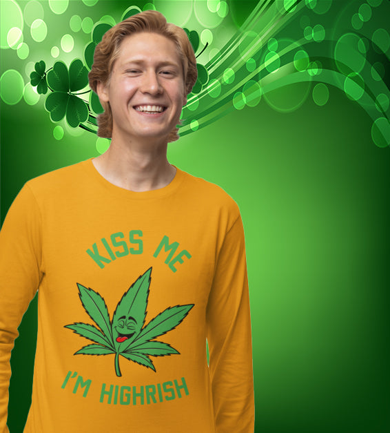  unisex t-shirt featuring a playful green cannabis leaf with a funny face, tongue out, and the words "Kiss Me I’m Highrish" in bold, festive lettering.