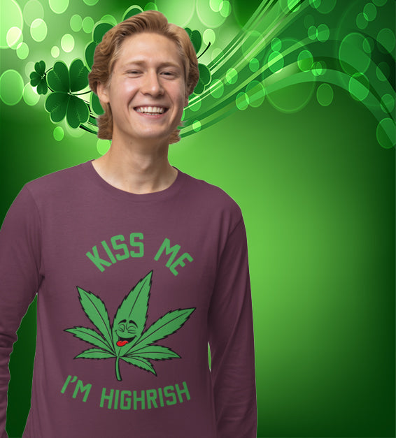  unisex t-shirt featuring a playful green cannabis leaf with a funny face, tongue out, and the words "Kiss Me I’m Highrish" in bold, festive lettering.