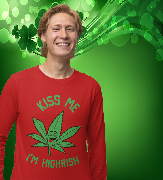  unisex t-shirt featuring a playful green cannabis leaf with a funny face, tongue out, and the words "Kiss Me I’m Highrish" in bold, festive lettering.