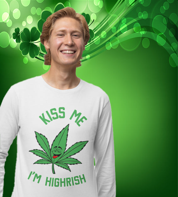  unisex t-shirt featuring a playful green cannabis leaf with a funny face, tongue out, and the words "Kiss Me I’m Highrish" in bold, festive lettering.