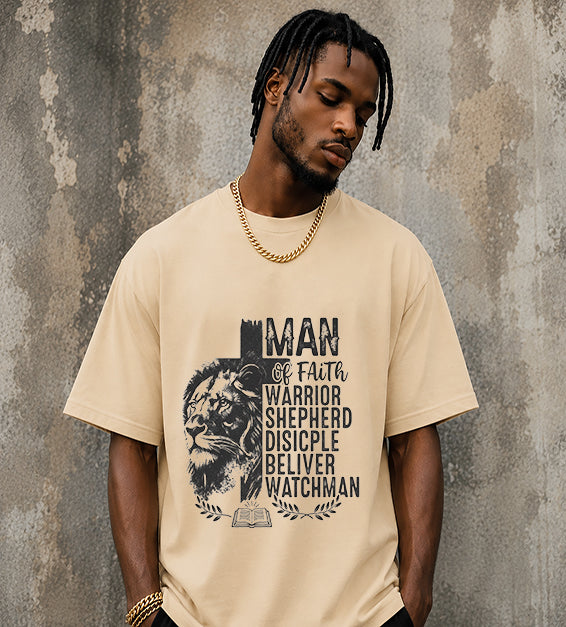 Christian men's t-shirt featuring Lion of Judah artwork with Man of Faith typography including Warrior, Shepherd, Disciple, Believer, and Watchman on a sand dune colored shirt.