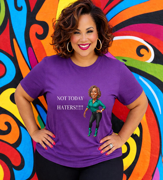 Woman wearing a team purple Bella Canvas t-shirt with motivational “Not Today Haters” graphic design in front of colorful mural background.