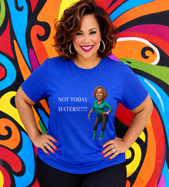 Woman wearing a true royal Bella Canvas t-shirt with motivational “Not Today Haters” graphic design in front of colorful mural background.