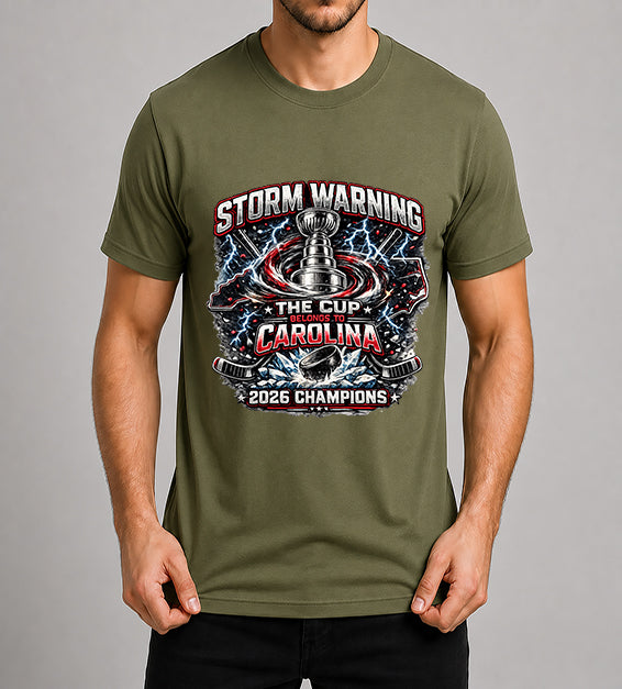 Olive hockey fan t-shirt featuring championship-inspired trophy artwork with storm graphics, shattered ice, hockey puck, and bold athletic typography celebrating a championship season.