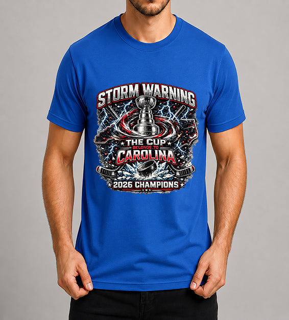 Blue hockey fan t-shirt featuring championship-inspired trophy artwork with storm graphics, shattered ice, hockey puck, and bold athletic typography celebrating a championship season.