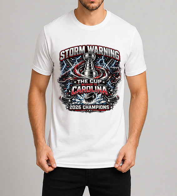 White hockey fan t-shirt featuring championship-inspired trophy artwork with storm graphics, shattered ice, hockey puck, and bold athletic typography celebrating a championship season.