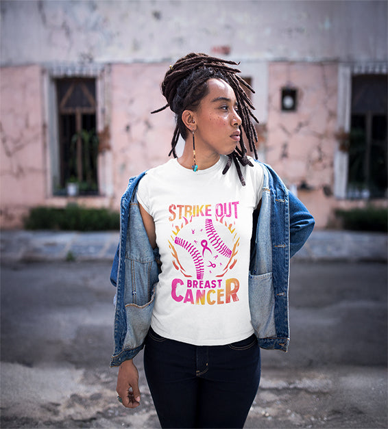 Black woman wearing a white t-shirt with a pink softball and “Strike Out” text – awareness graphic shirt
