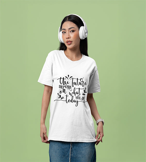 A woman wearing headphones and a white T-shirt that reads “The Future Depends on What You Do Today” in a cursive black font, posing against a soft green background.