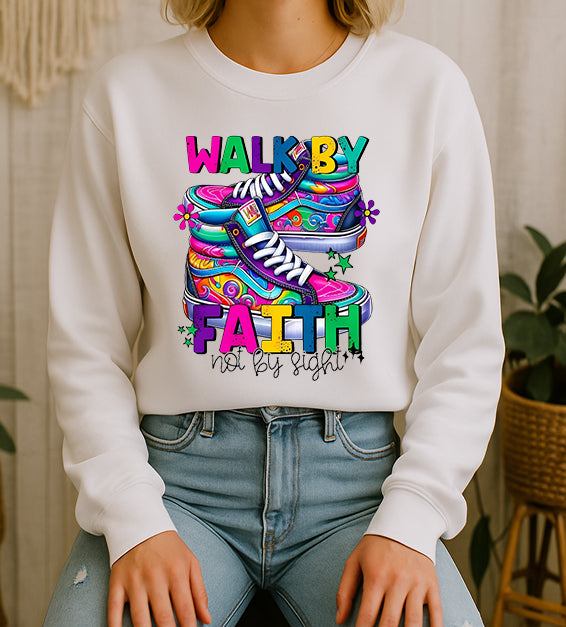 Woman wearing white Christian T-shirt with colorful “Walk By Faith Not By Sight” design.